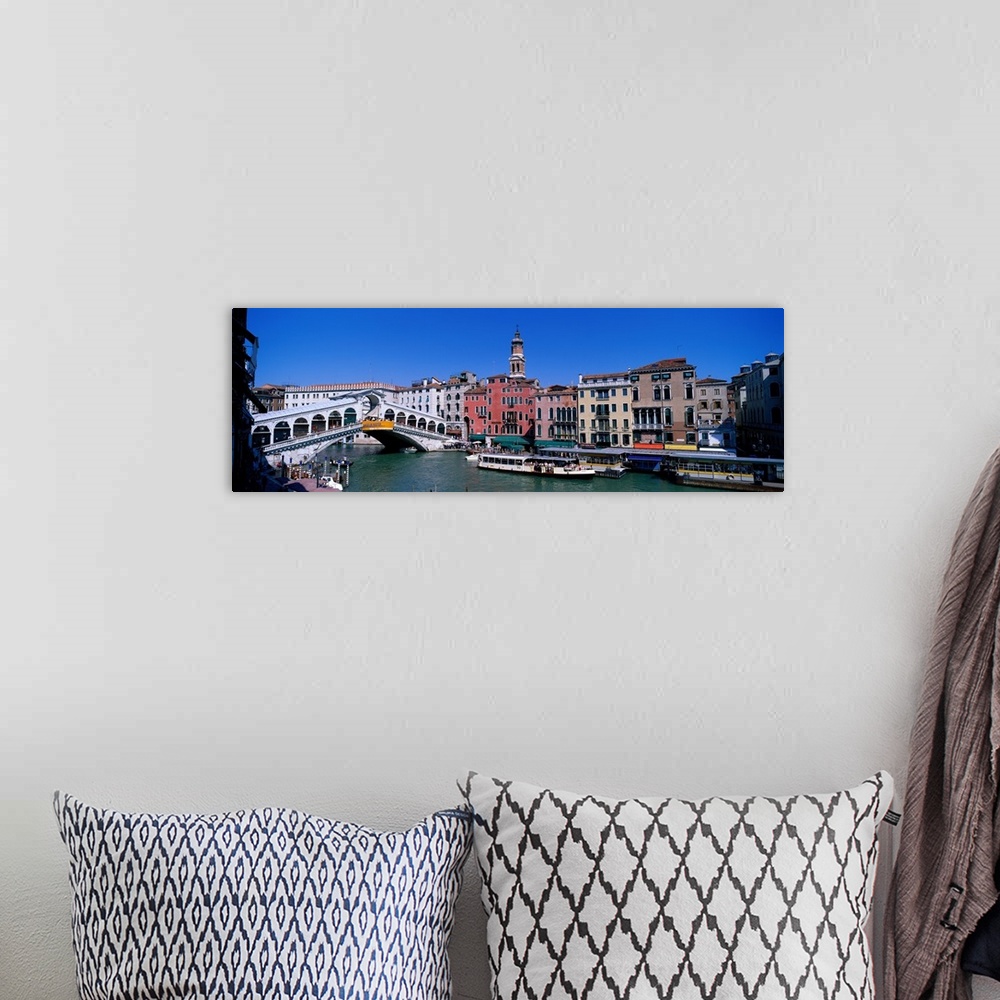 A bohemian room featuring This panoramic view shows the Rialto bridge over the grand canal in Venice with buildings lining ...