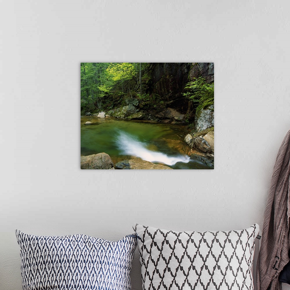 A bohemian room featuring Large horizontal photograph of a pool of water at the bottom of Sabbaday Falls, surrounded by roc...