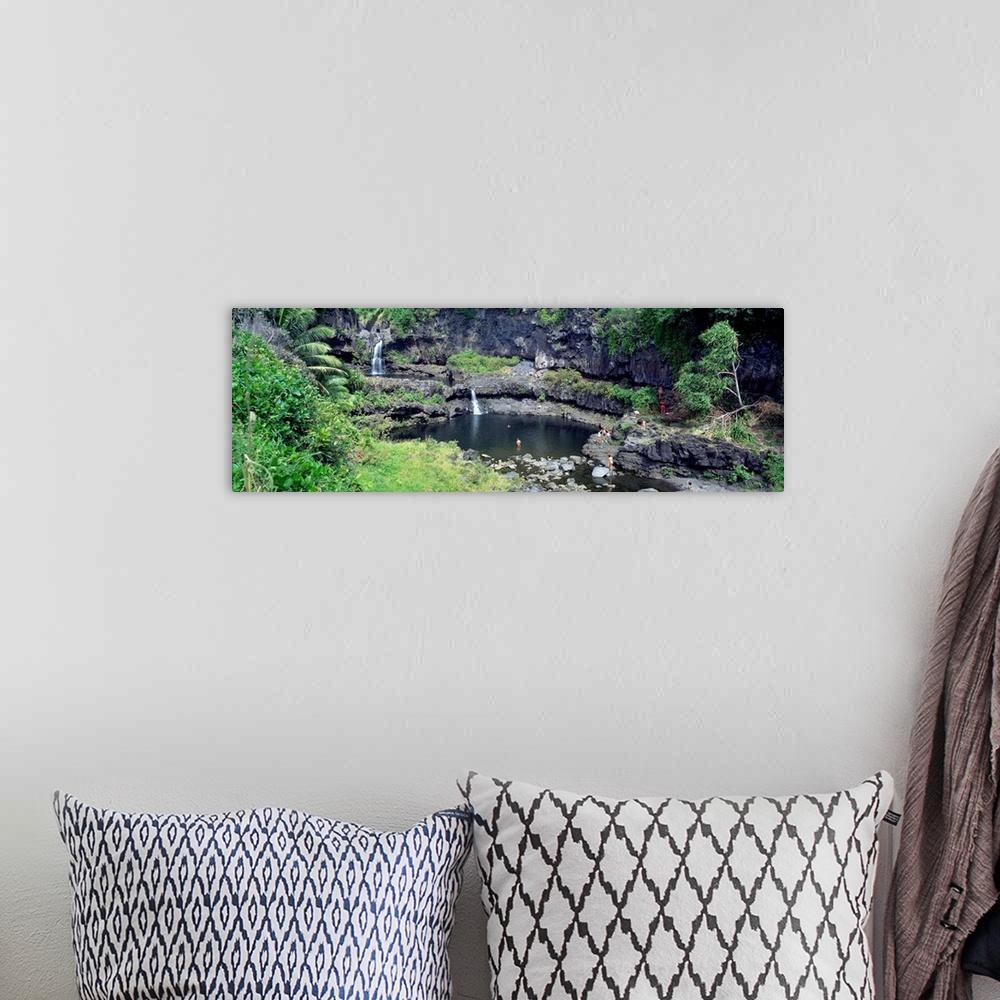 A bohemian room featuring This large panoramic piece is a photograph taken of small waterfalls that go into a pool of water...