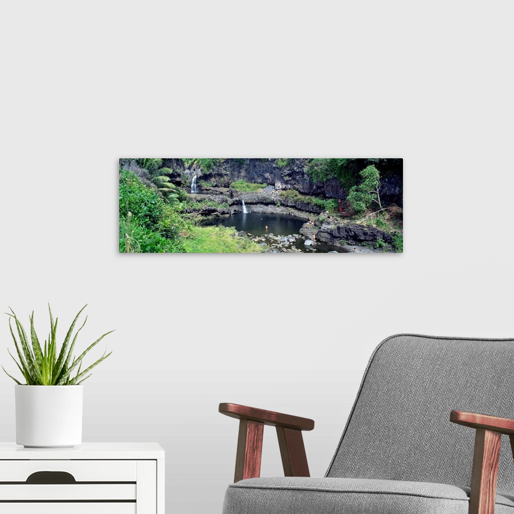 A modern room featuring This large panoramic piece is a photograph taken of small waterfalls that go into a pool of water...