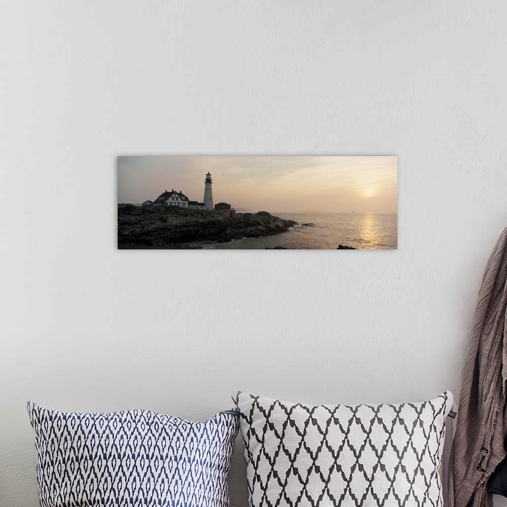 A bohemian room featuring Wide angle photograph of a lighthouse sitting on a cliff that reaches far out into the ocean. The...