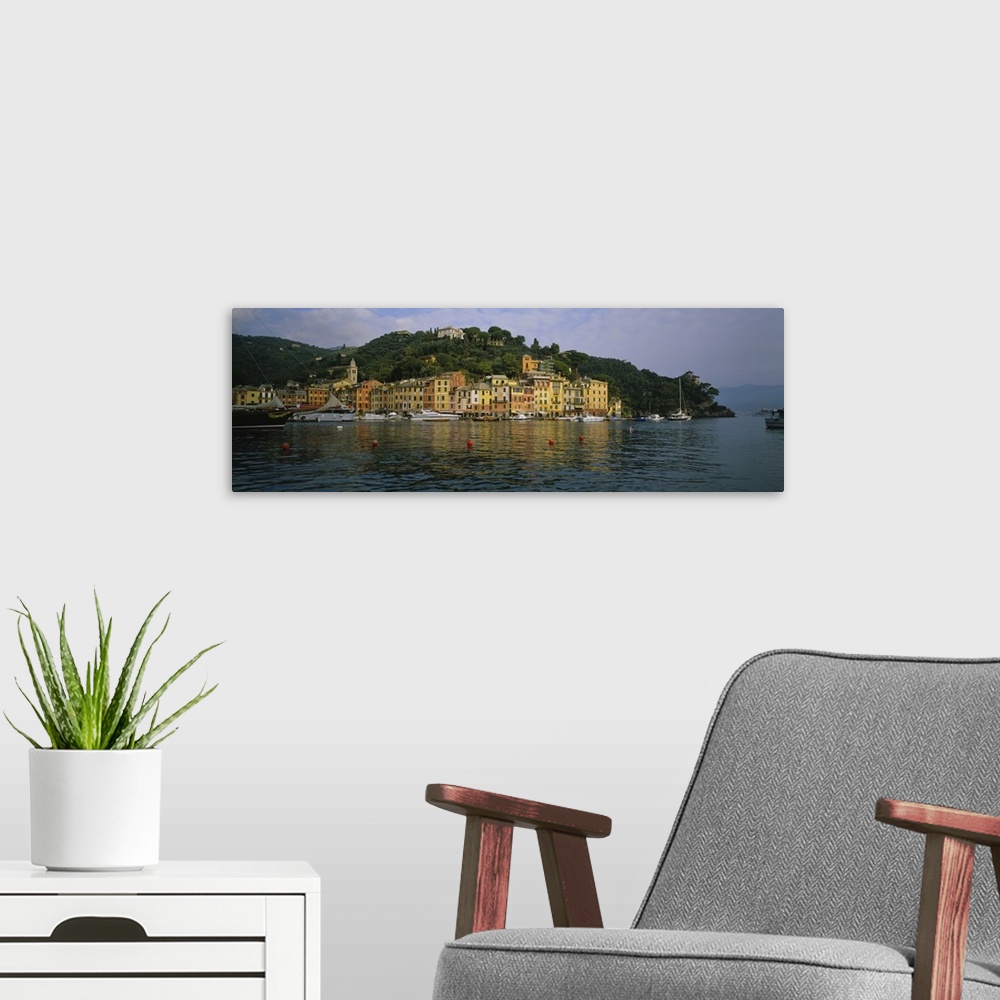A modern room featuring This is a panoramic photograph of the picturesque harbor taken from on the water.
