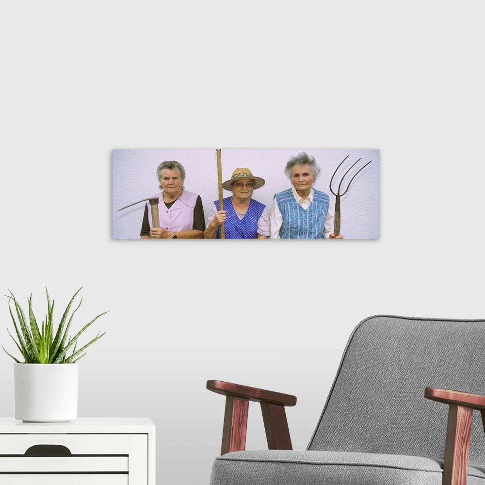 A modern room featuring Portrait of three senior women holding gardening tools, Baden-Wurttemberg, Germany