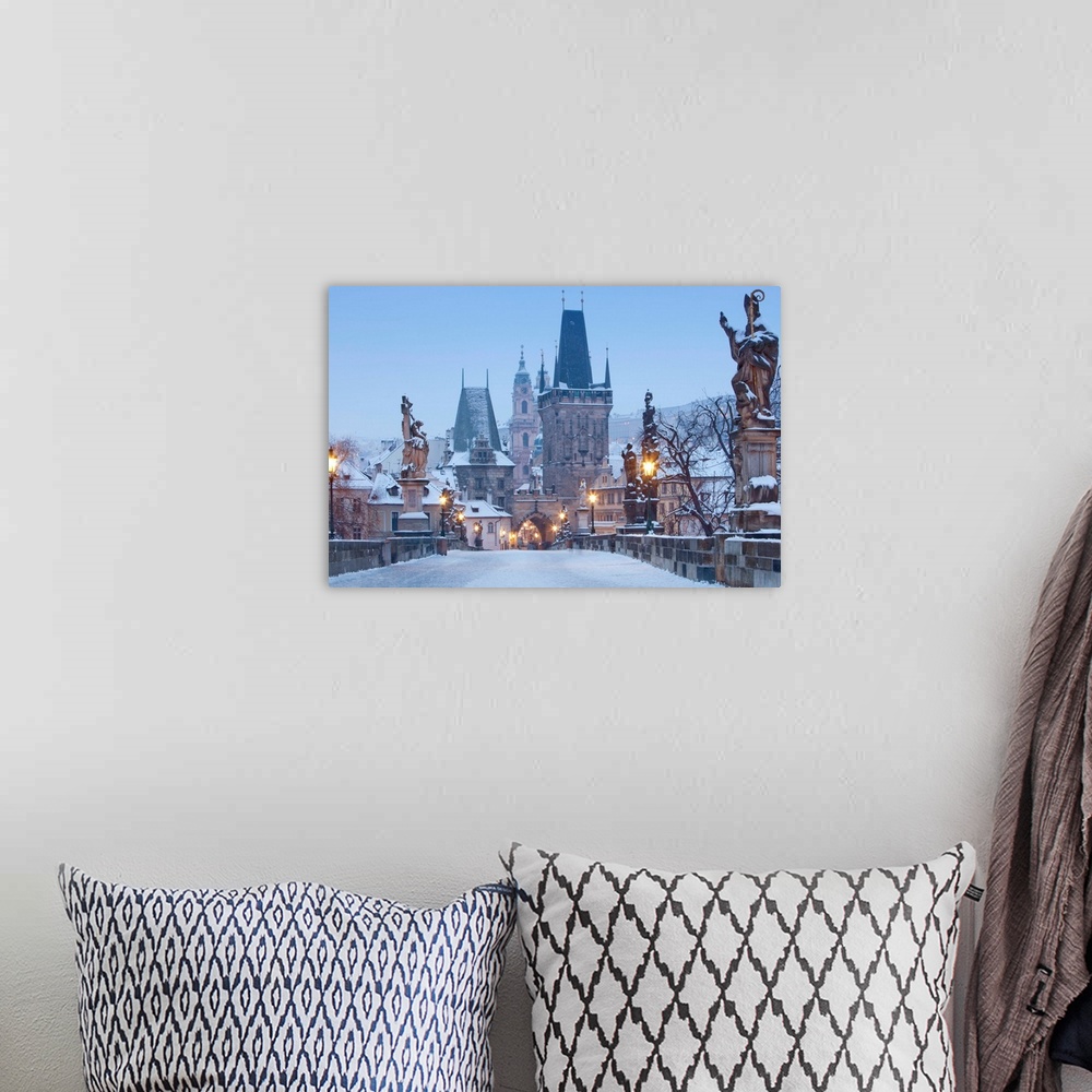 A bohemian room featuring Prague, Charles Bridge tower and St. Nicolas church on winter morning.
