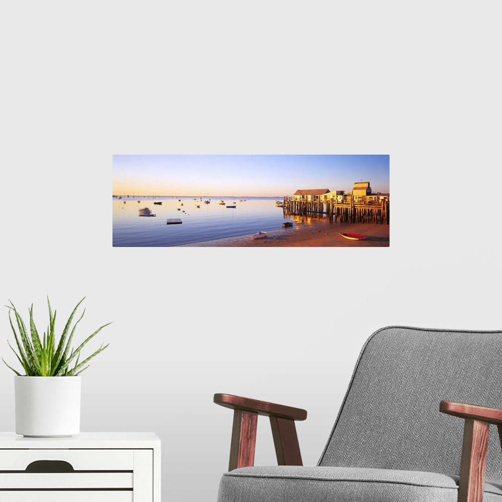 A modern room featuring Picturesque panoramic photograph of a beach and small pier in Provinetown, Massachusettes. Small ...