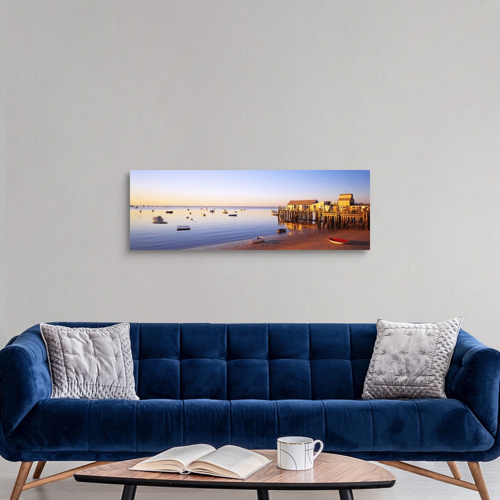 A modern room featuring Picturesque panoramic photograph of a beach and small pier in Provinetown, Massachusettes. Small ...