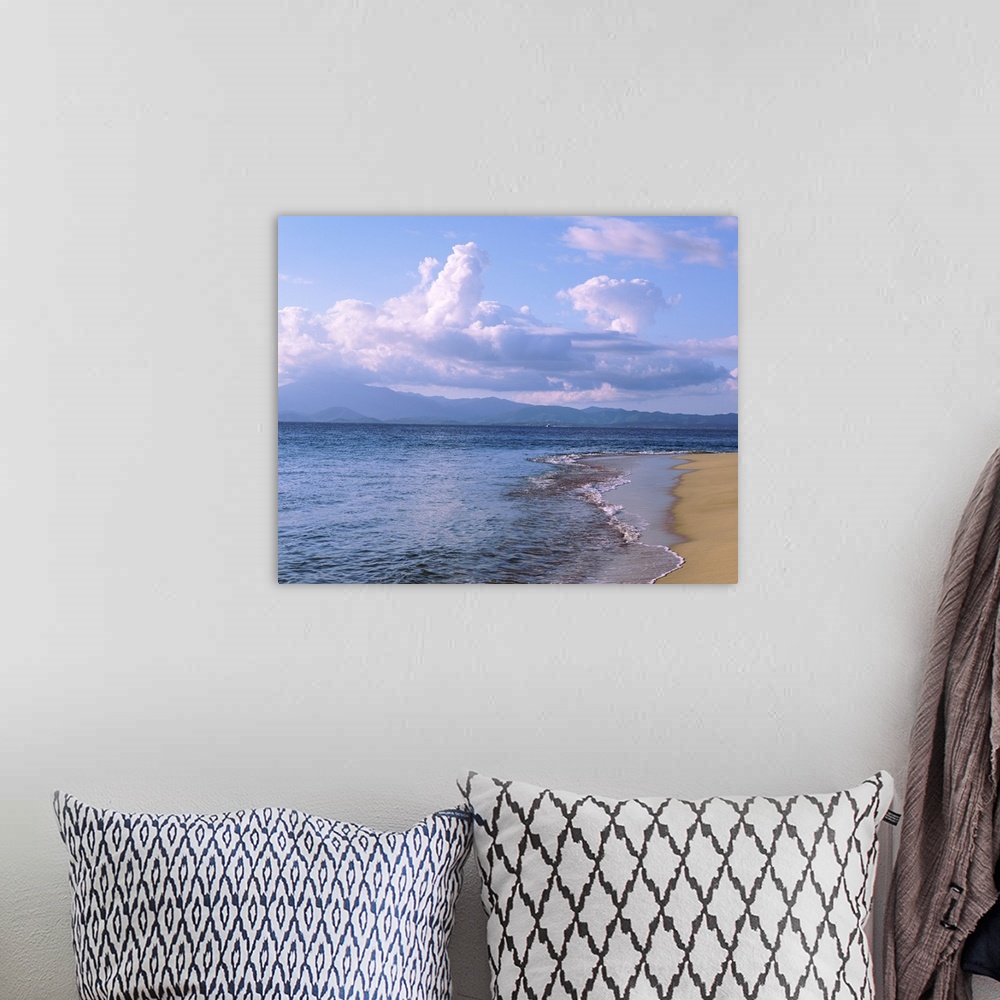 A bohemian room featuring Scenic photograph of the calm sea and beach in the late afternoon under large clouds in the Carib...