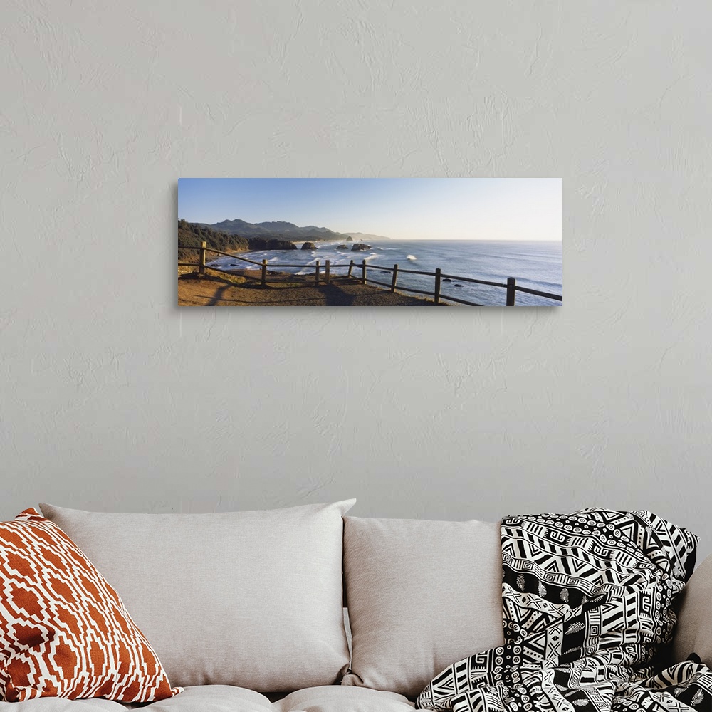 A bohemian room featuring Giant panoramic photograph featuring a railing overlooking Cannon Beach in Oregon (OR) on a sunny...