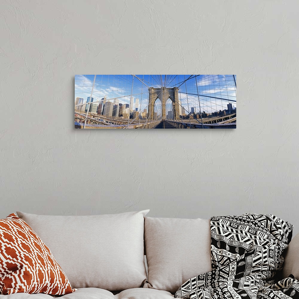 A bohemian room featuring Panoramic photograph taken from a landmark overpass in New York as it overlooks a busy skyline.  ...