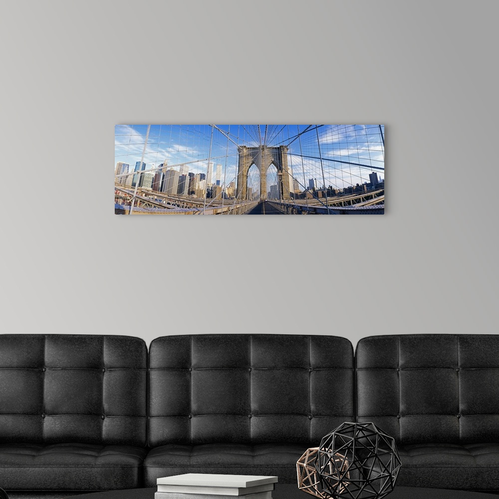 A modern room featuring Panoramic photograph taken from a landmark overpass in New York as it overlooks a busy skyline.  ...