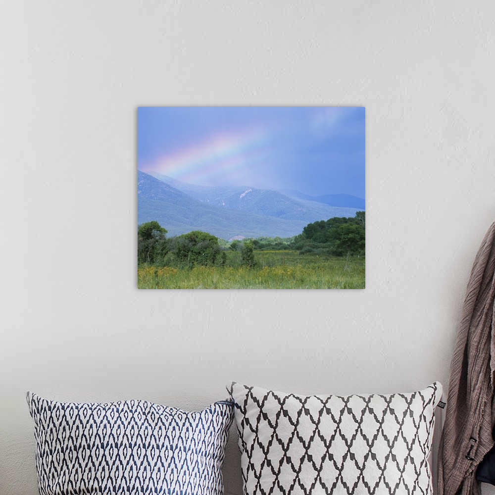 A bohemian room featuring Rainbow over a mountain range, Taos, Taos County, New Mexico