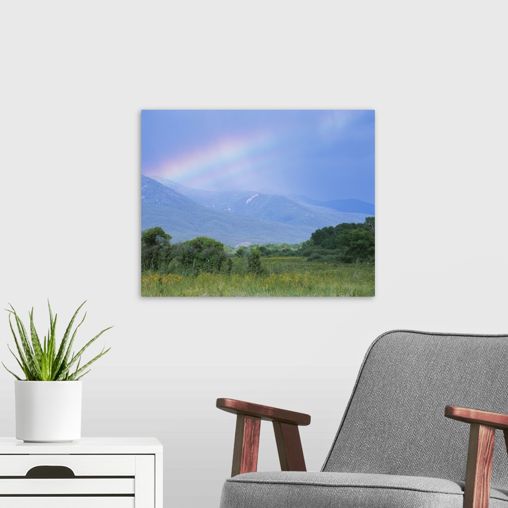 A modern room featuring Rainbow over a mountain range, Taos, Taos County, New Mexico