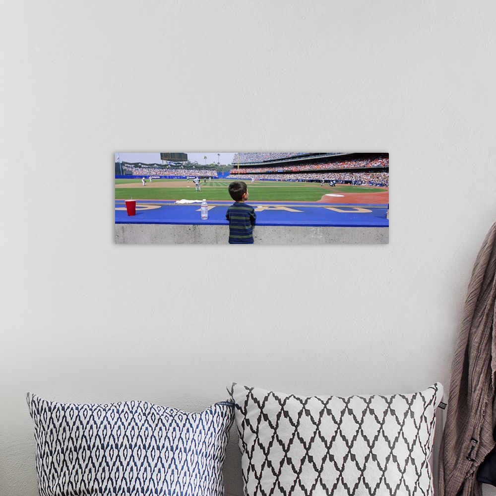 A bohemian room featuring This decorative all wart is a panoramic photograph of a child watching a baseball game from a dug...
