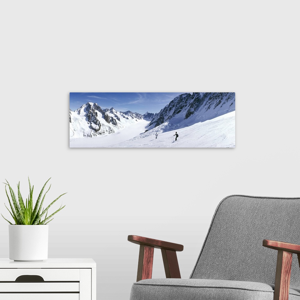A modern room featuring Rear view of two people skiing, Les Grands Montets, Chamonix, France