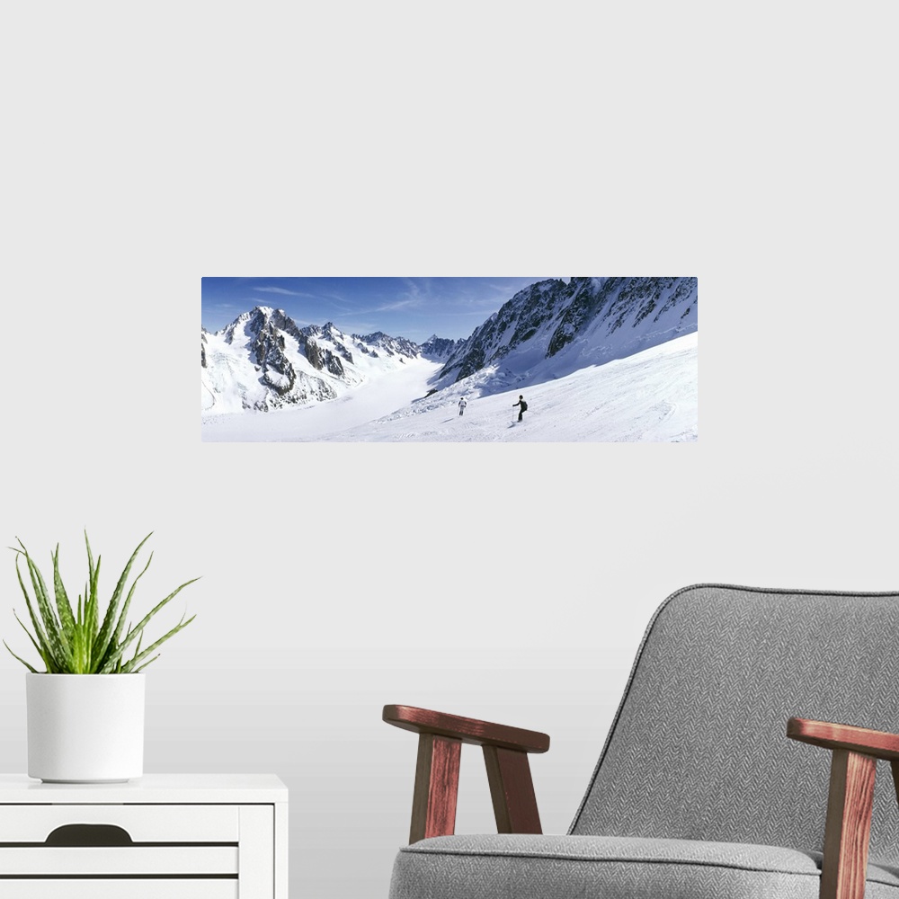 A modern room featuring Rear view of two people skiing, Les Grands Montets, Chamonix, France