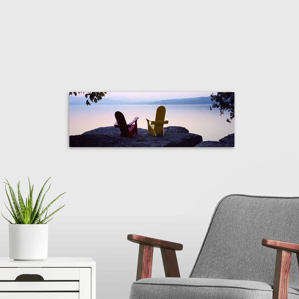 A modern room featuring Horizontal photograph on a big canvas of two adirondack chairs sitting at the edge of a rocky cli...