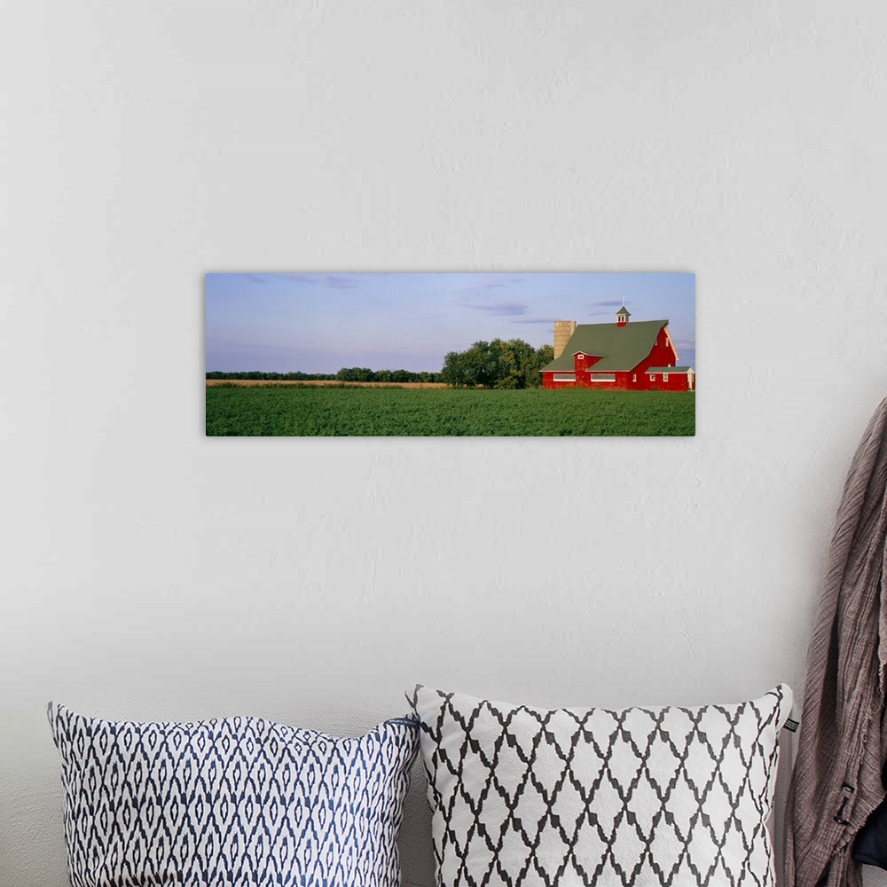 A bohemian room featuring Panoramic image print of a barn in the middle of a crop field.