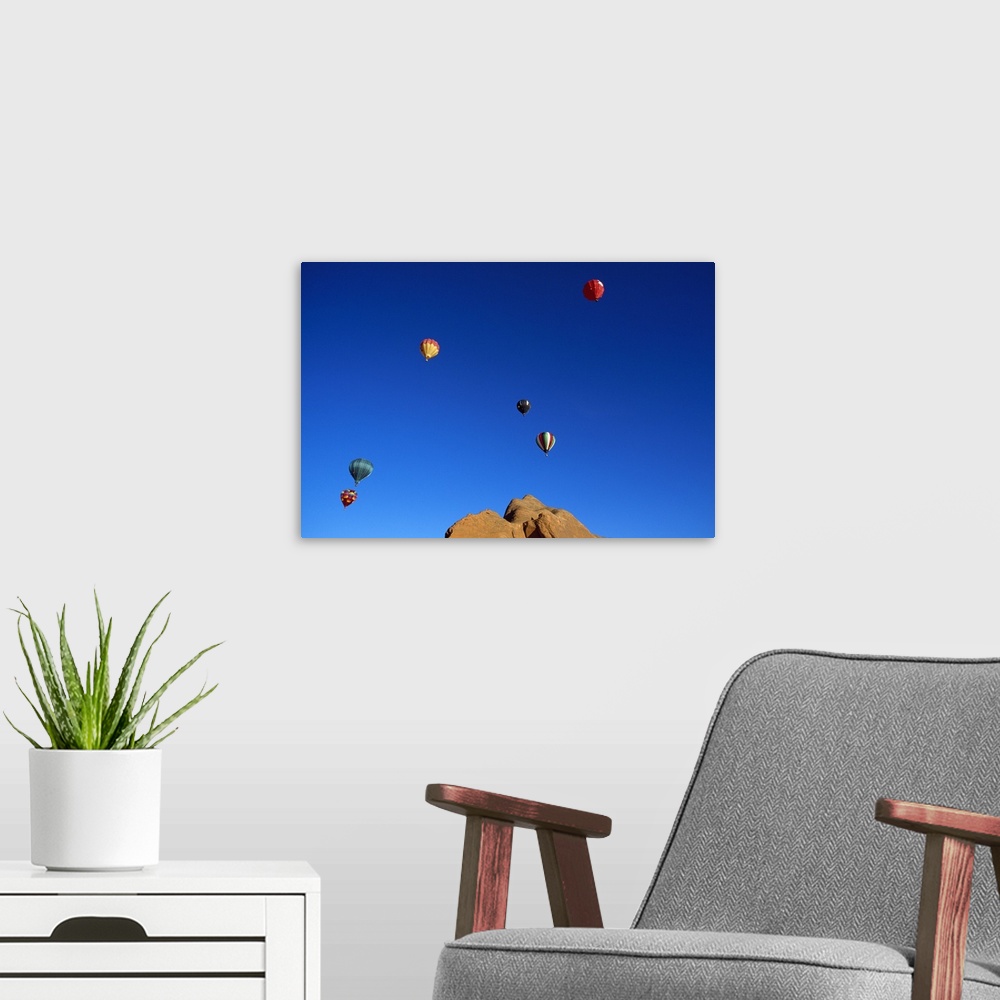 A modern room featuring Red rock cliffs, hot air balloons in blue sky, Gallup, New Mexico