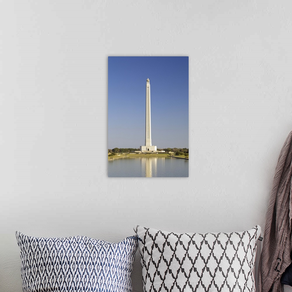 A bohemian room featuring Reflection of a monument in the pool, San Jacinto Monument, Texas, USA