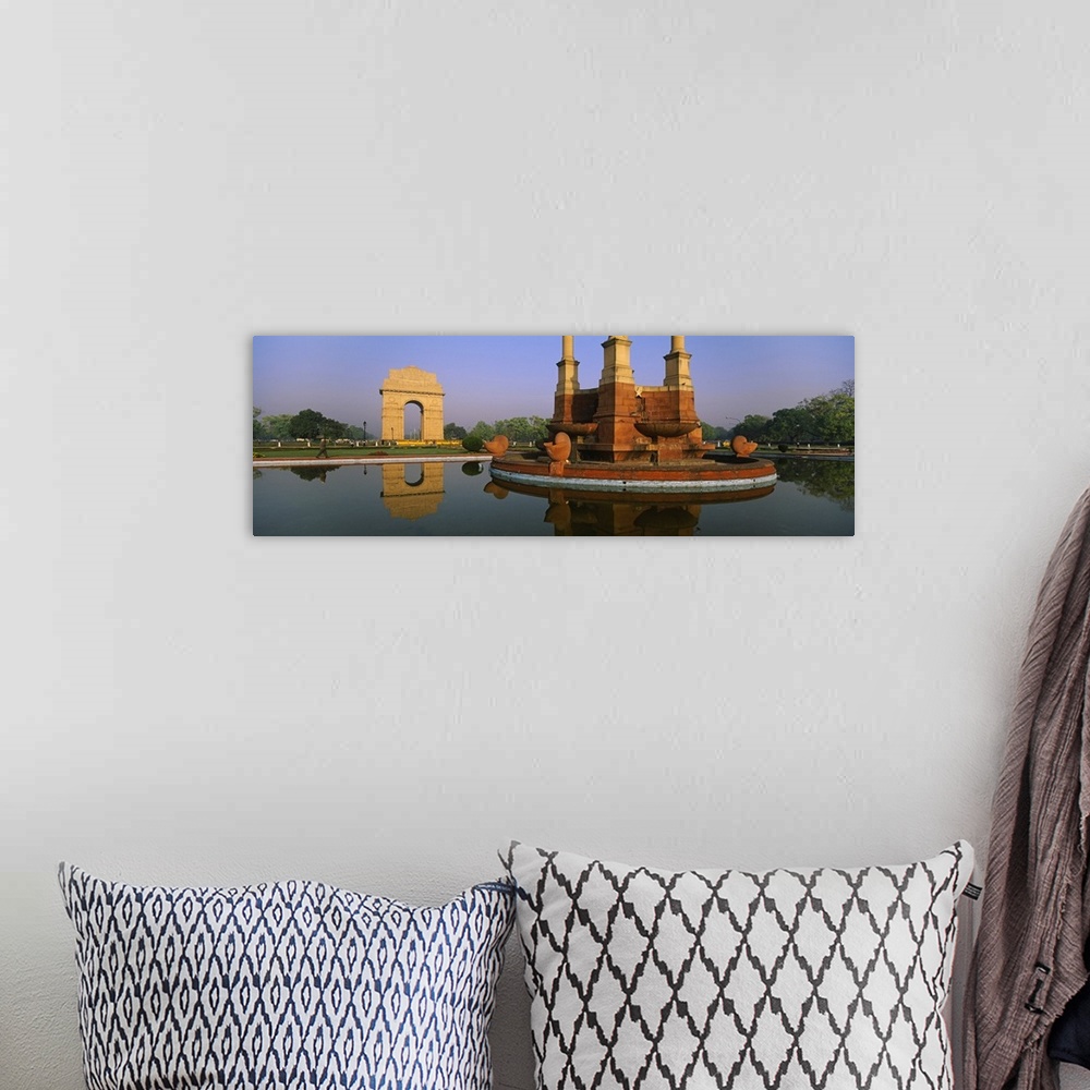 A bohemian room featuring Reflection of a monument in water, India Gate, New Delhi, India