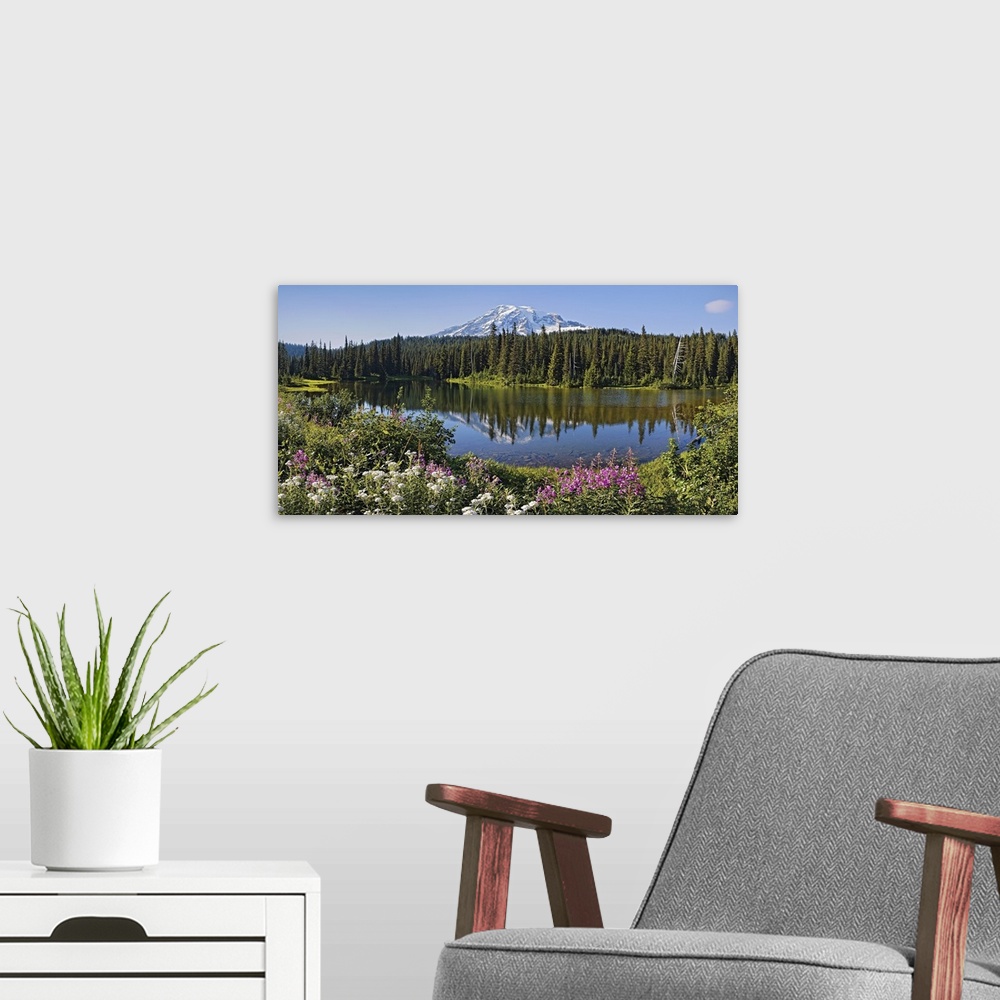 A modern room featuring Decorative artwork for the home or office of a mountain with pine trees in front that reflect in ...