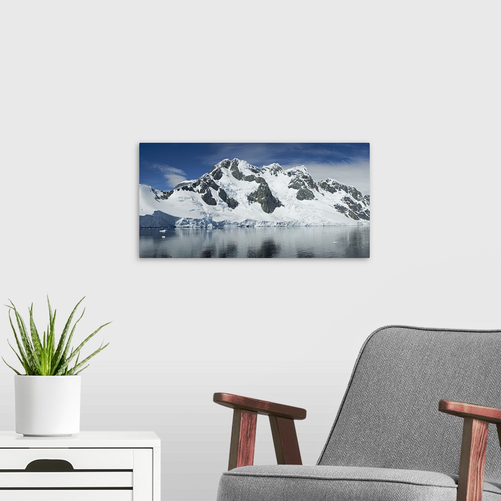 A modern room featuring Reflection of a snow covered mountain in water, Antarctic Peninsula, Antarctica