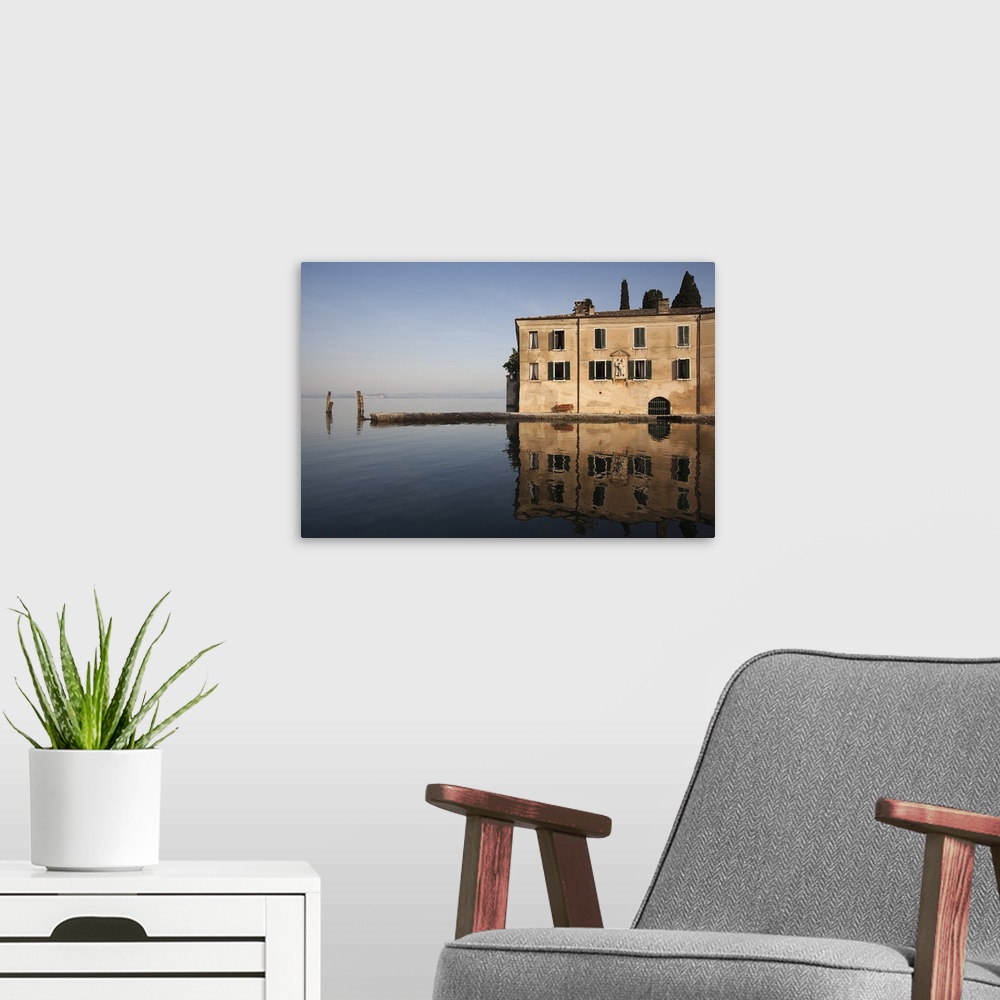 A modern room featuring Reflection of building in a lake, Punta San Vigilio, Lake Garda, Garda