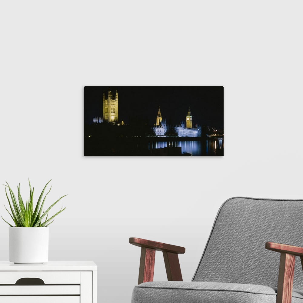 A modern room featuring Reflection of buildings in a river lit up at night, Big Ben, House Of Parliament, London, England