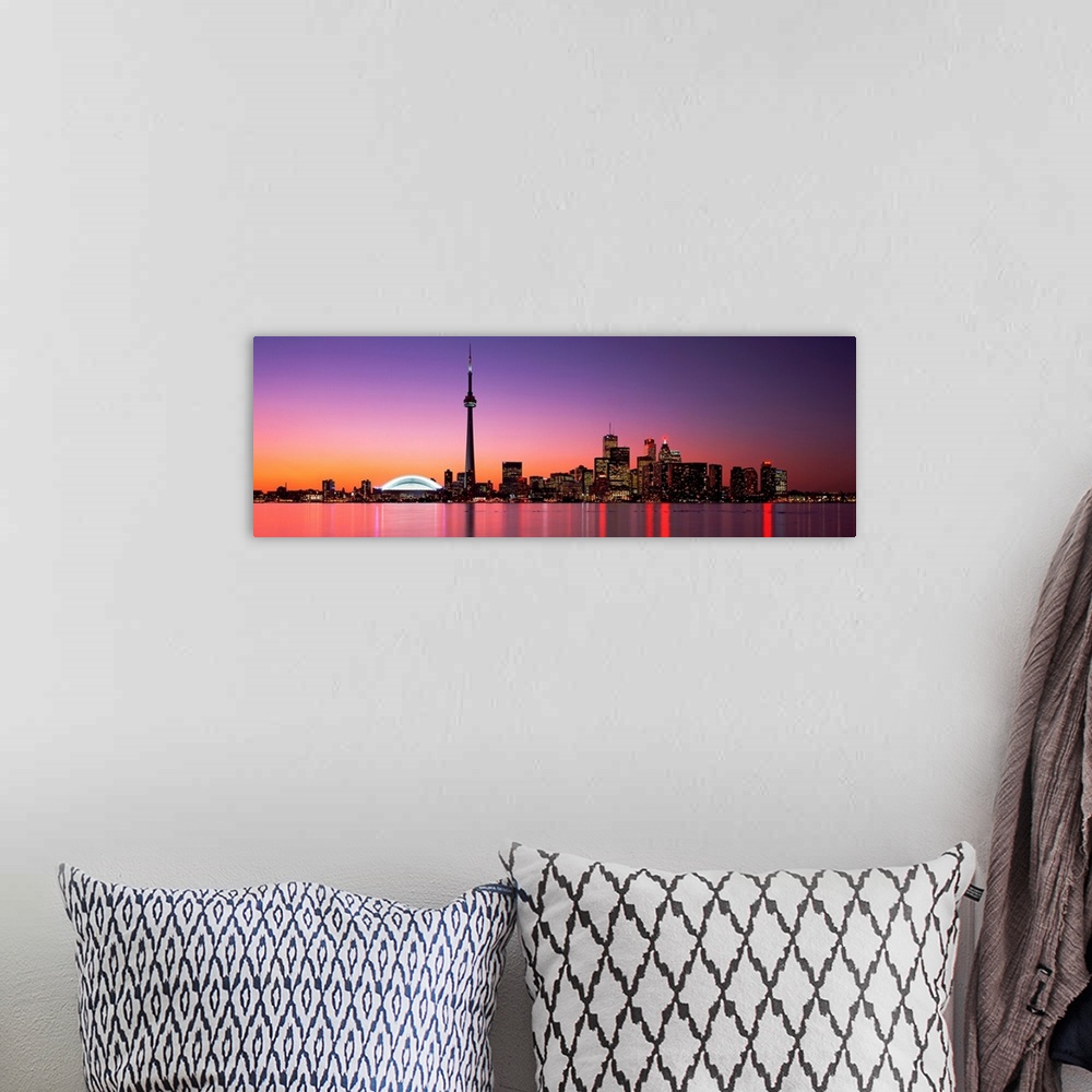 A bohemian room featuring A panoramic photograph of the city skyline glowing in the night.