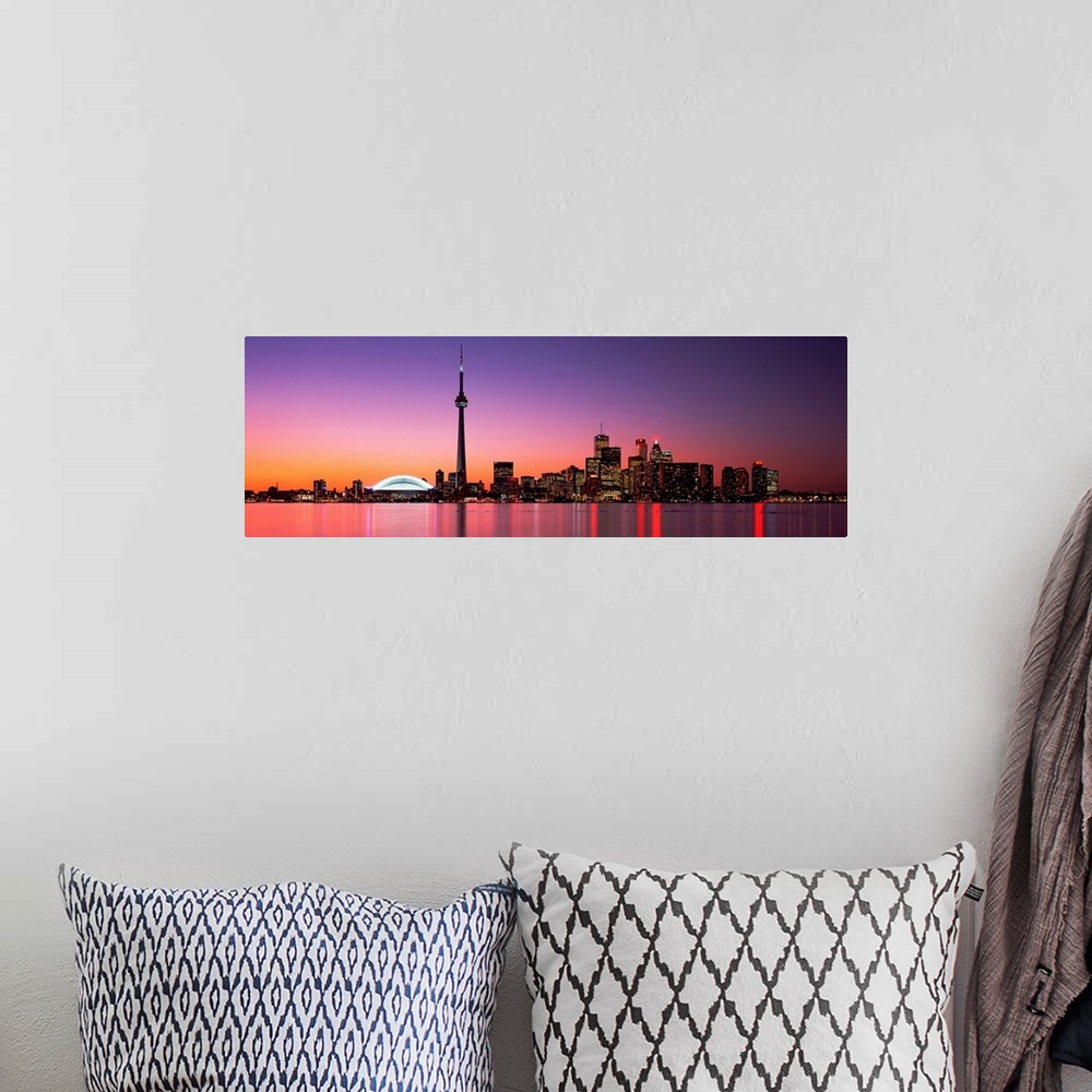 A bohemian room featuring A panoramic photograph of the city skyline glowing in the night.