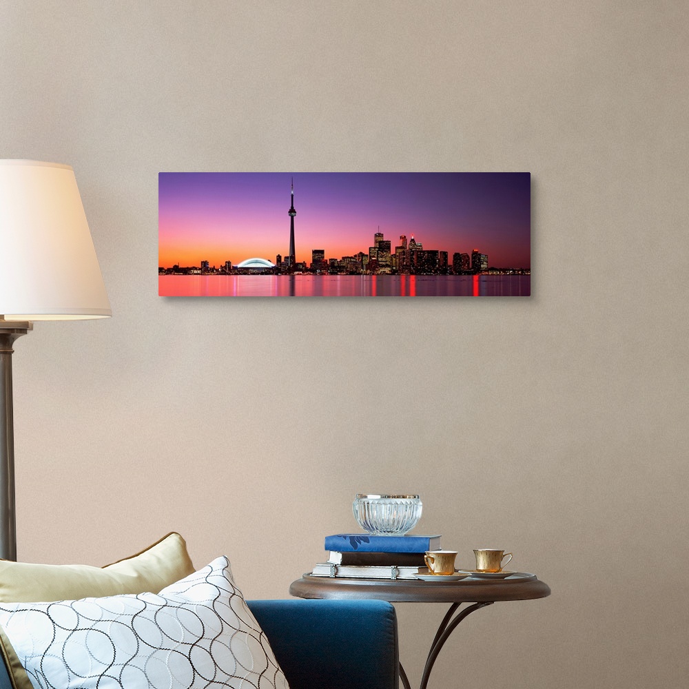 A traditional room featuring A panoramic photograph of the city skyline glowing in the night.