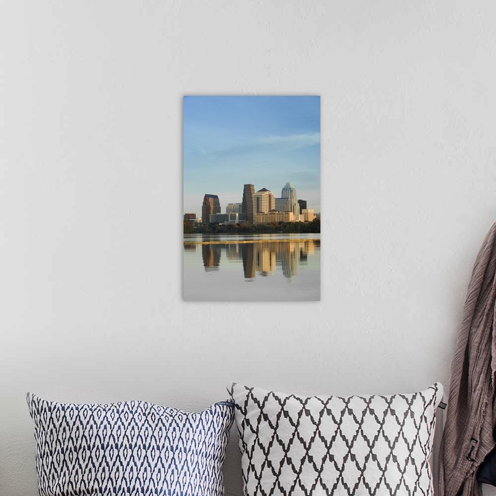 A bohemian room featuring Skyscrapers in Austin reflect down in the body of water that sits just in front of the city.