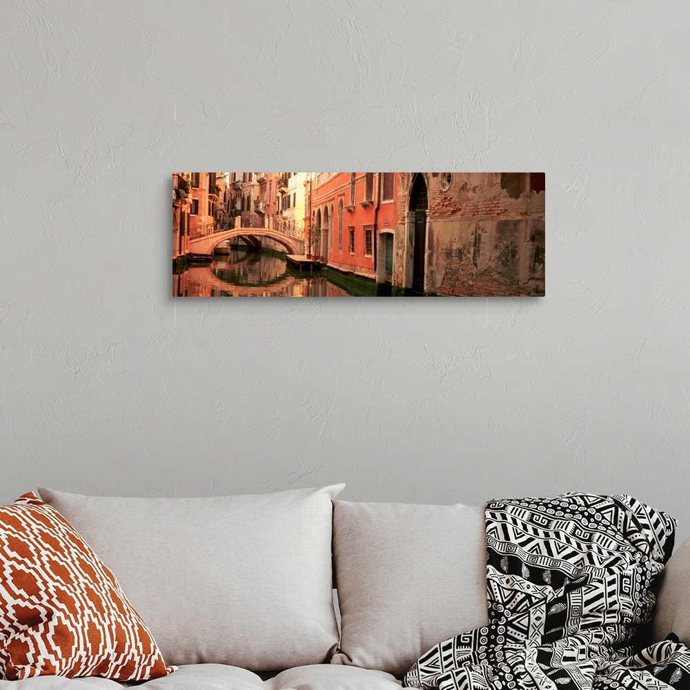 A bohemian room featuring Panoramic photograph focuses on buildings and bridges following a canal in Venice, Italy.  Locate...