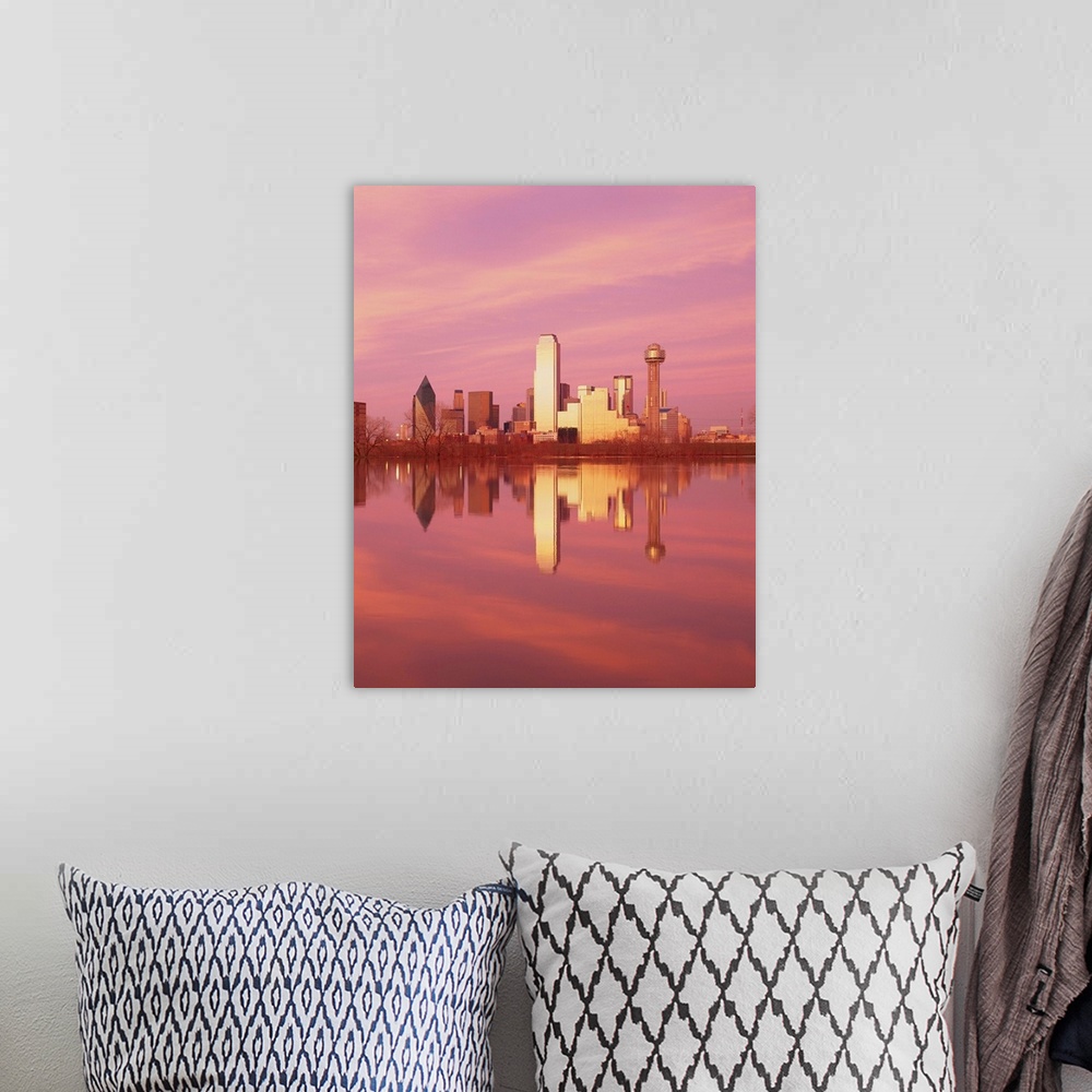 A bohemian room featuring During sunset, the Dallas skyline is photographed from across a body of water that it reflects in.