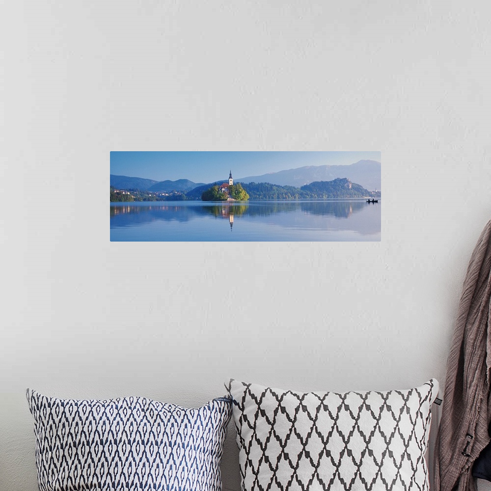 A bohemian room featuring Giant, horizontal photograph of a mountain landscape and buildings reflecting in the waters of La...