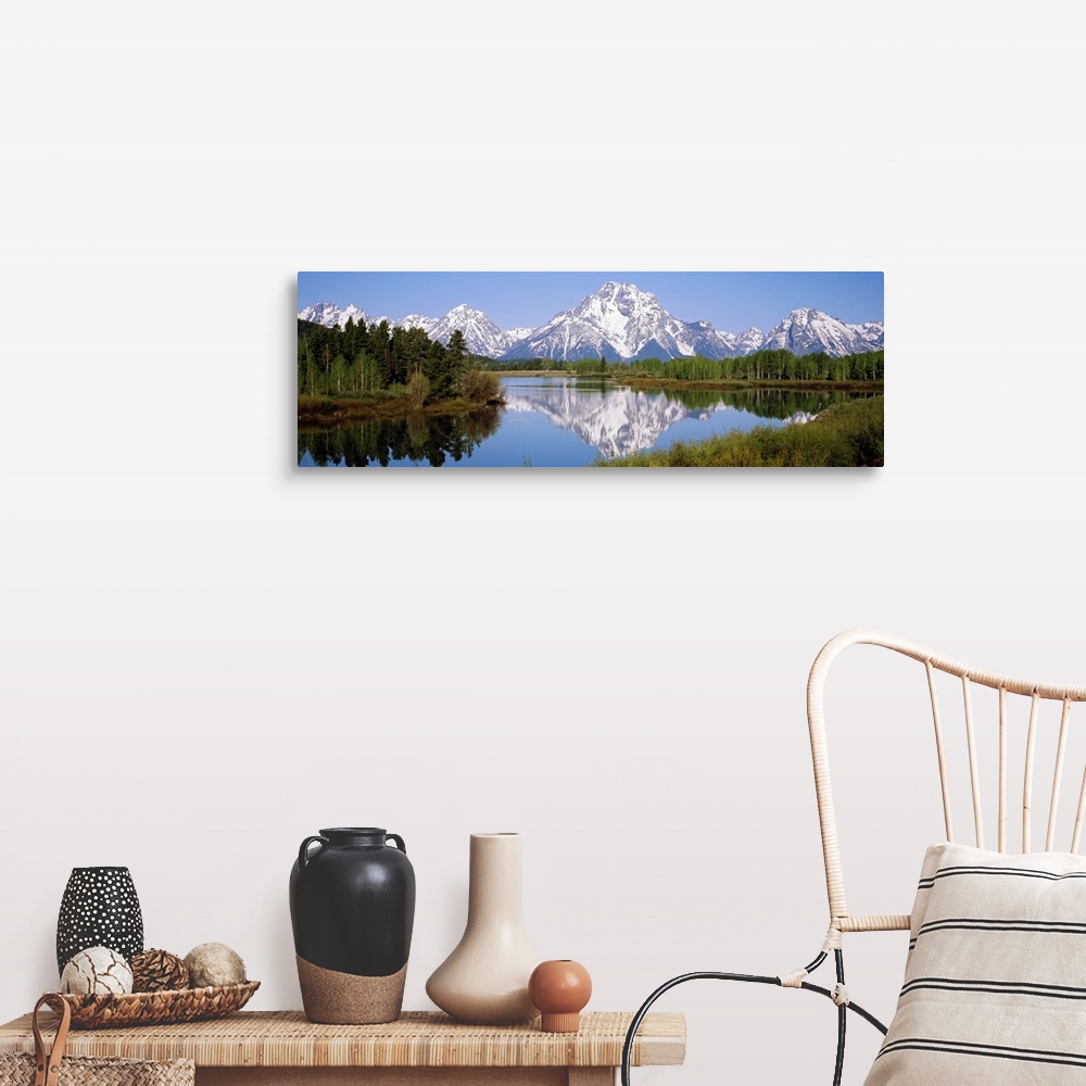 A farmhouse room featuring Panoramic photograph on a giant canvas of mountain reflections in the Snake River, surrounded by ...