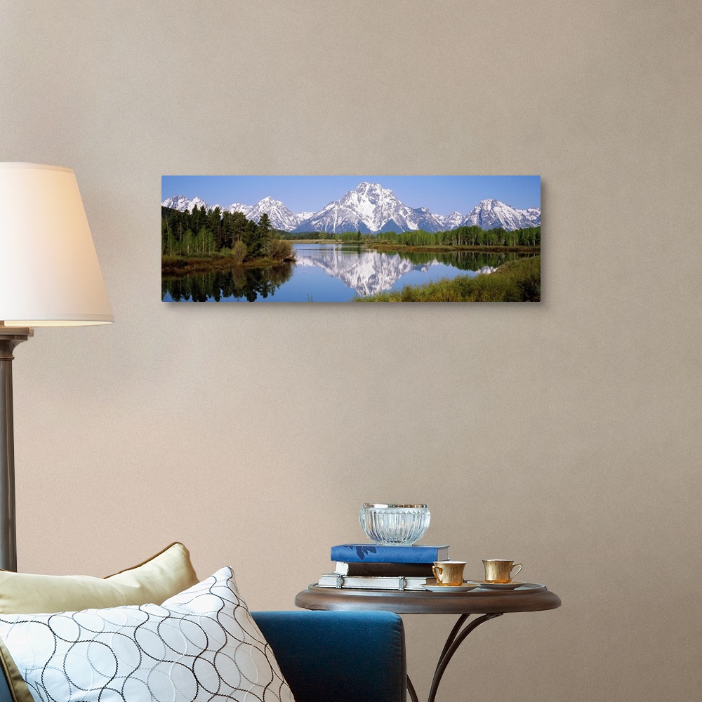 A traditional room featuring Panoramic photograph on a giant canvas of mountain reflections in the Snake River, surrounded by ...