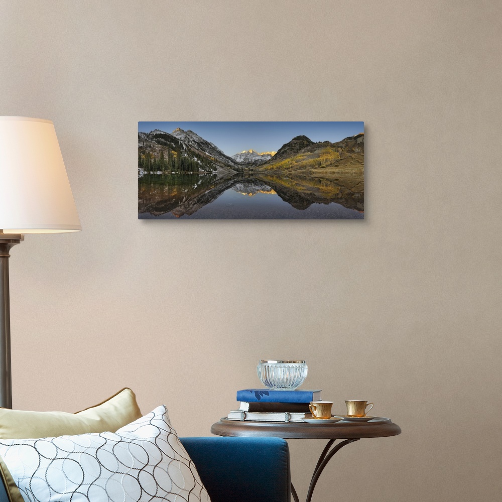 A traditional room featuring Panoramic photograph shows a mountain range filled with patches of snow and trees as they perfect...