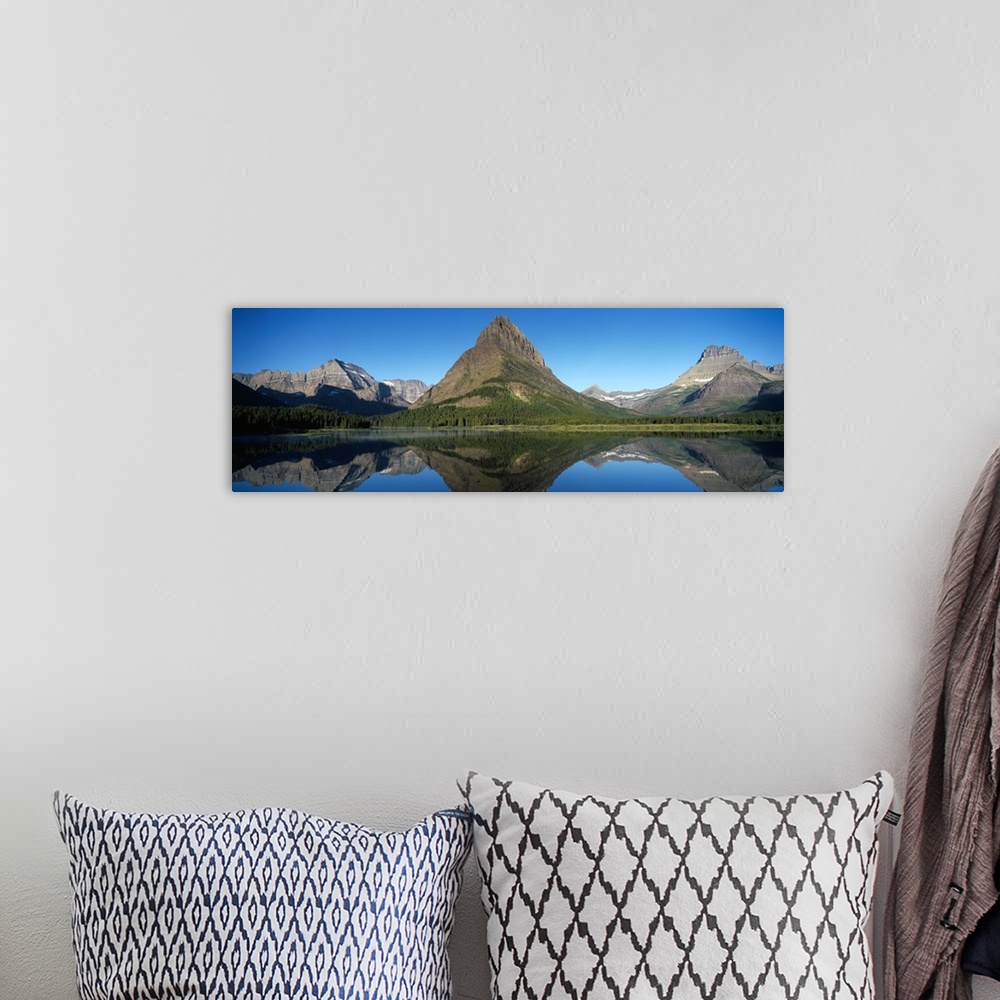 A bohemian room featuring Reflection of mountains in a lake, Swiftcurrent Lake, Many Glacier, US Glacier National Park, Mon...