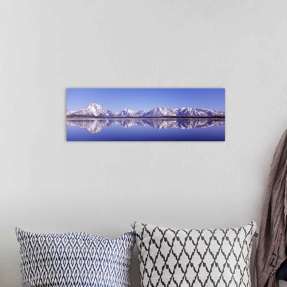 A bohemian room featuring Reflection of mountains in a lake, Teton Range, Jackson Lake, Grand Teton National Park, Wyoming,