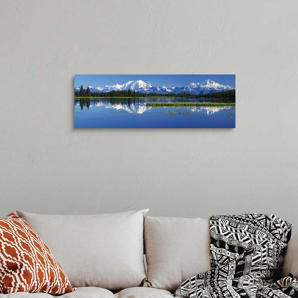 A bohemian room featuring Panoramic photograph on a big canvas of snow covered Mt Foraker and Mt McKinley behind a line of ...