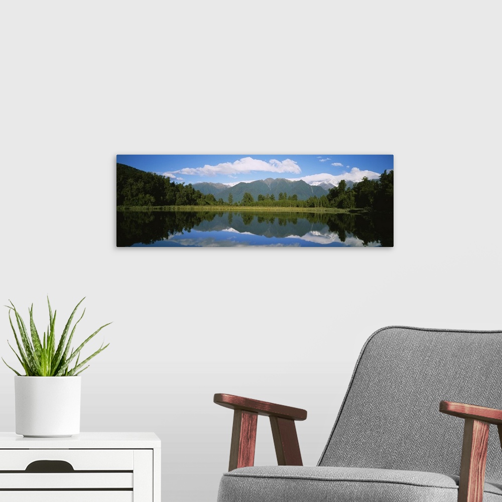 A modern room featuring Reflection of mountains in water, Lake Matheson, Westland National Park, South Island, New Zealand