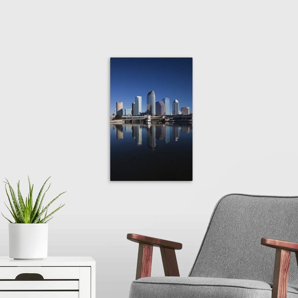 A modern room featuring Tall image on canvas of buildings in Tampa reflected in the waterfront.