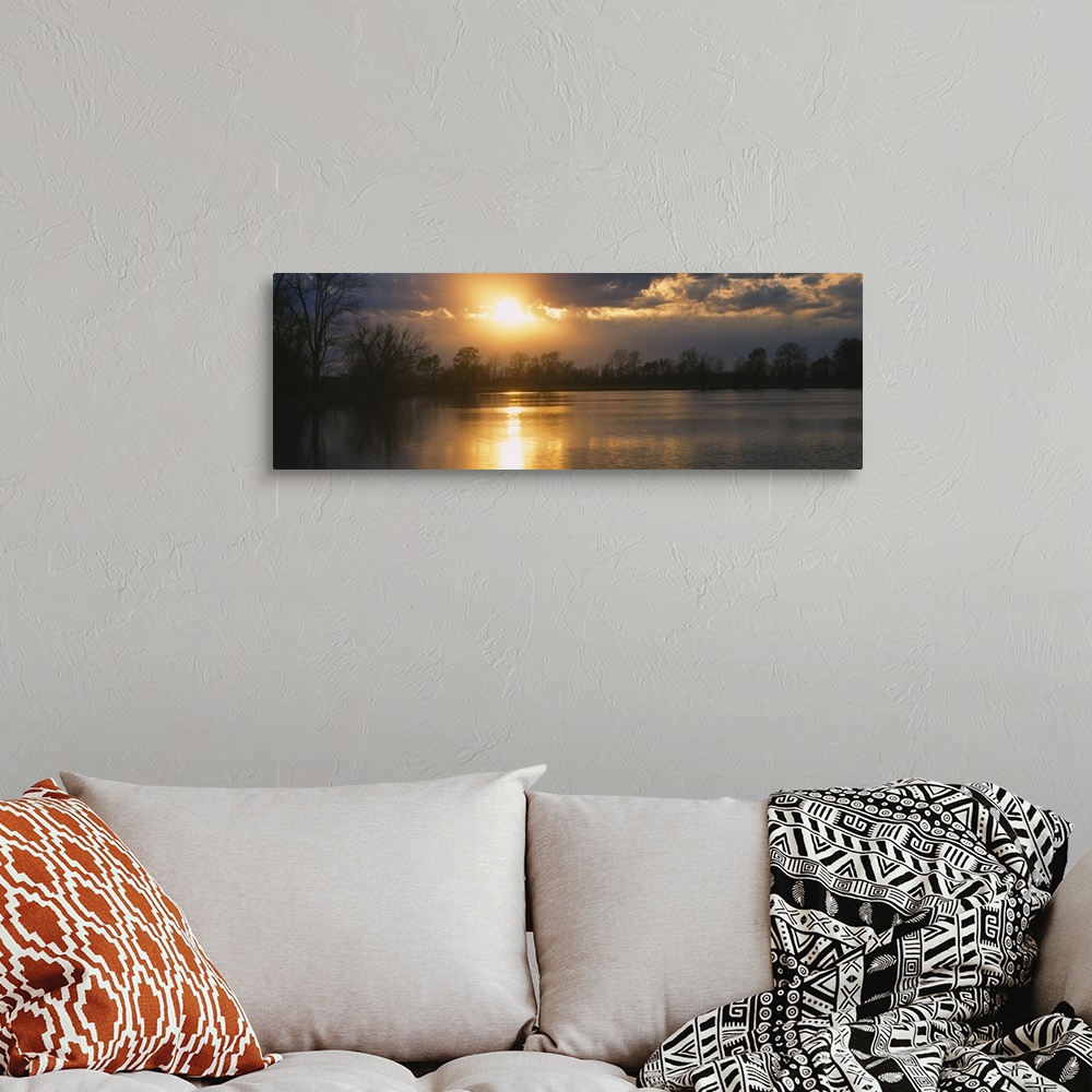 A bohemian room featuring Sunset reflecting over a lake in West Memphis, Arkansas.