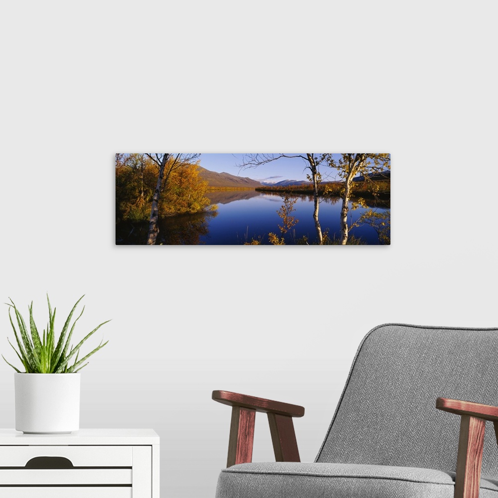 A modern room featuring Reflection of trees and mountains in a river, Vistas River, Nikkaluokta, Lapland, Sweden