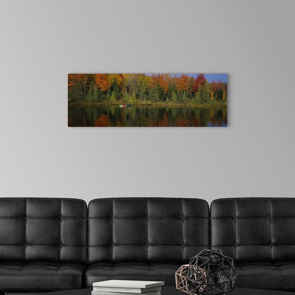 A modern room featuring A lone canoer on the lake during the fall in Antigo, Wisconsin.