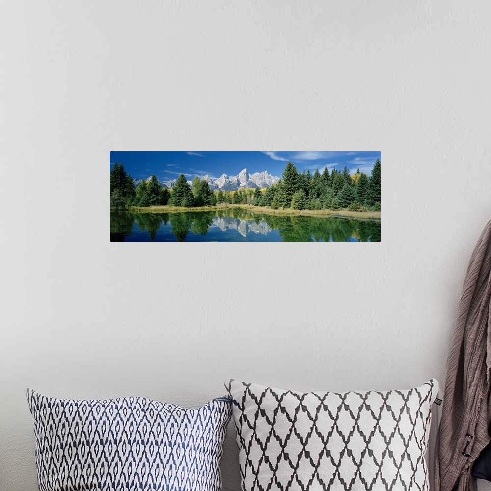 A bohemian room featuring Panoramic photo print of a water with a reflection of the rugged mountains and forest in the dist...