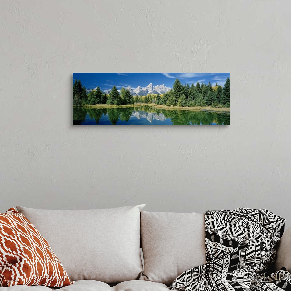 A bohemian room featuring Panoramic photo print of a water with a reflection of the rugged mountains and forest in the dist...