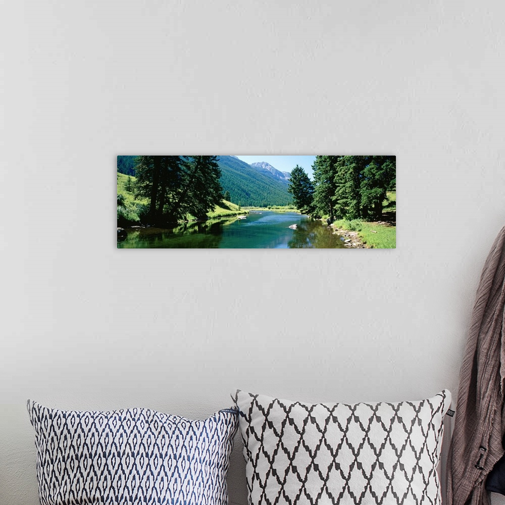 A bohemian room featuring Panoramic photograph looking down the Boulder River, surrounded by trees and mountain landscape i...