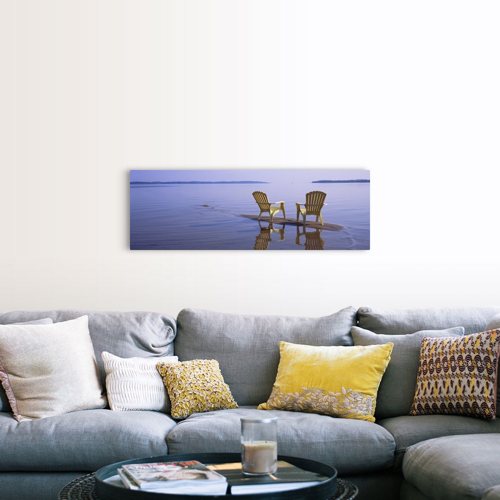 A farmhouse room featuring Panoramic photograph of two beach chairs sitting on top of sand bar with land in the far distance.